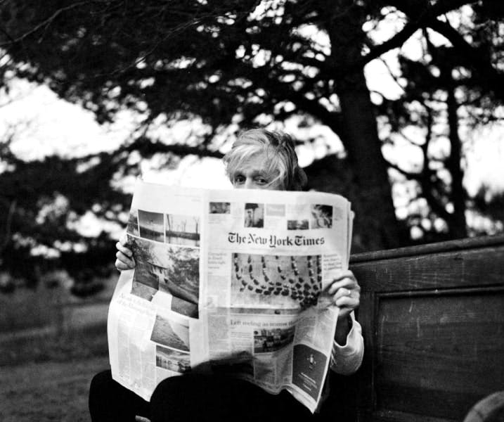Paul McCartney reading a newspaper